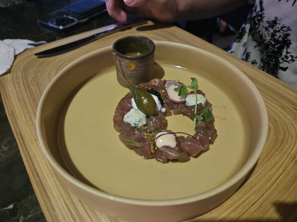고급스러운 접시에 동그랗게 담겨 나온 참치 타르타르 요리